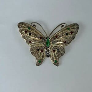 Ornate butterfly brooch with colorful gemstones.
