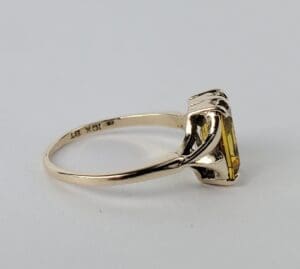 Gold ring with a yellow gemstone.