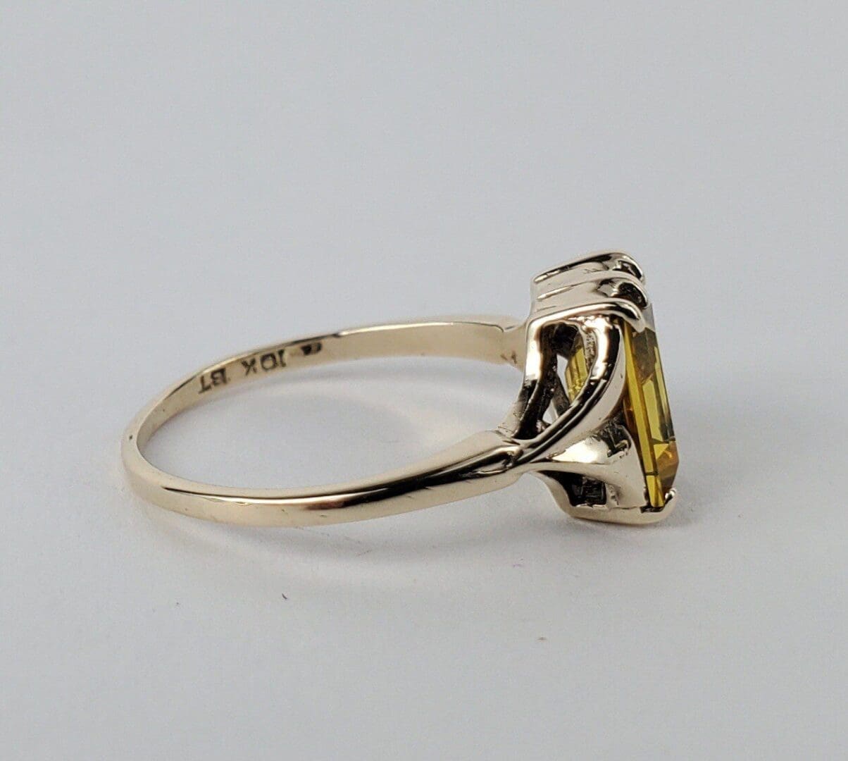 Gold ring with a yellow gemstone.