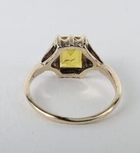 Gold ring with a yellow gemstone.