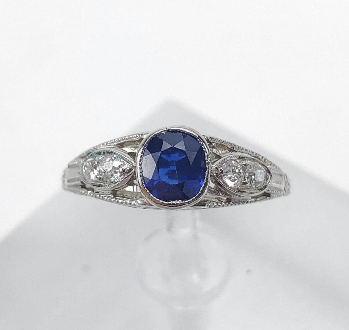 Silver ring with blue gemstone and diamonds.