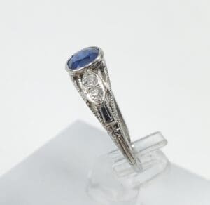 Vintage ring with blue gemstone and diamonds.