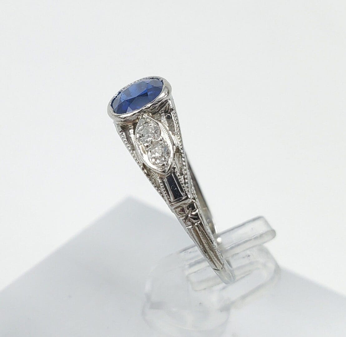 Vintage ring with blue gemstone and diamonds.