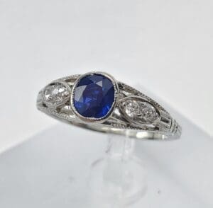 Silver ring with blue gemstone centerpiece.