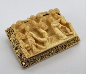 Intricate carved soapstone with decorative figures.