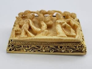 Ornate carved soapstone with intricate figures.
