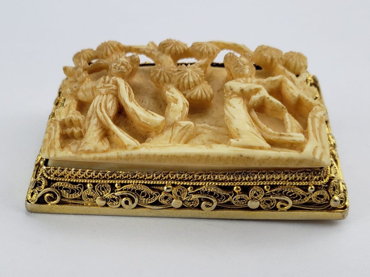 Ornate carved soapstone with intricate figures.