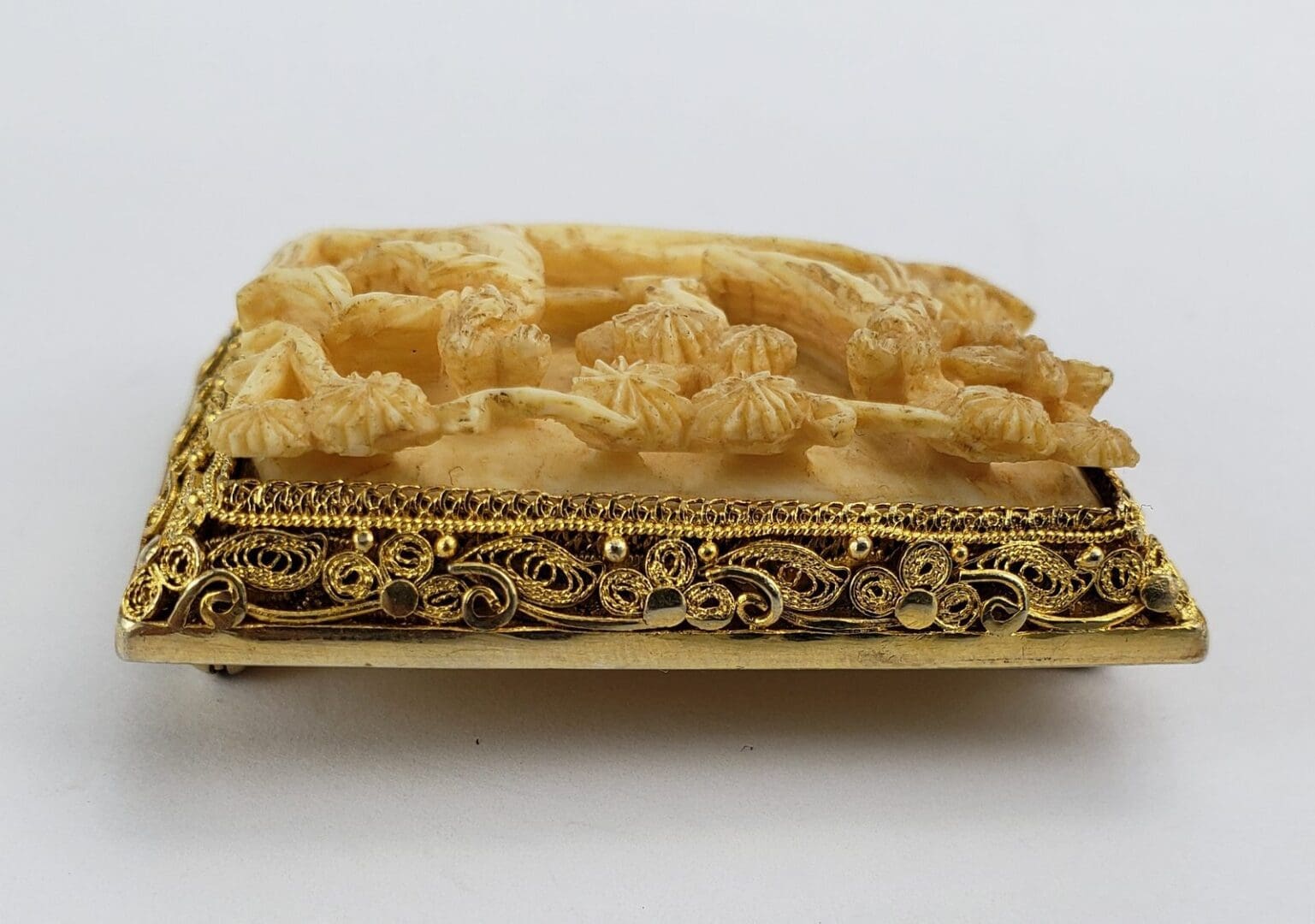 Ornate carved object with intricate gold detailing.