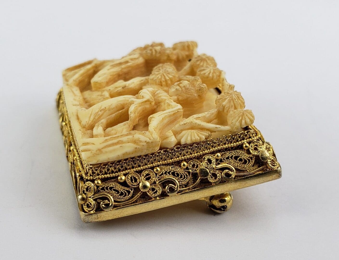 Ornate carved ivory and gold decorative box.