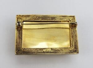 Back view of a gold rectangular brooch.