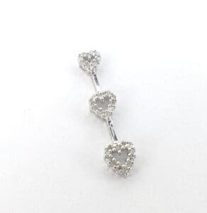 Three heart-shaped silver stud earrings.