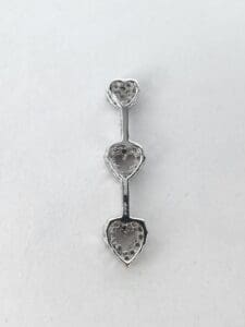 Silver heart-shaped earring with three sections.