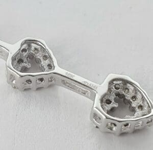 Silver heart-shaped jewelry setting.