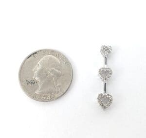 Quarter and triple heart jewelry piece.