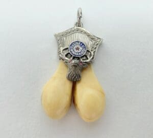 Ornate pendant with yellow tusk design.