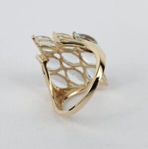 Gold ring with lattice design on top.