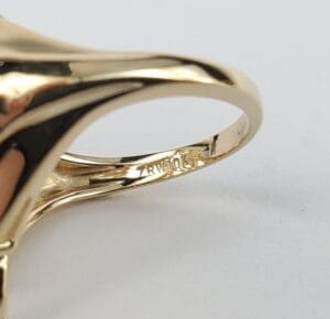 Gold ring with intricate design and engraving.