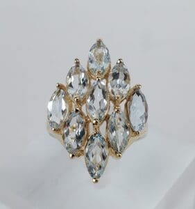 Gold ring with multiple marquise-cut gemstones.