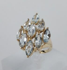 Gold ring with multiple marquise-cut gemstones.