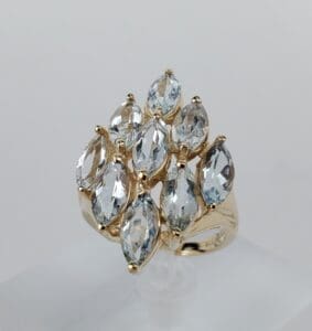 Gold ring with multiple marquise-cut gemstones.