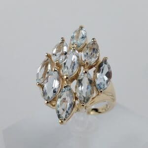 Gold ring with multiple marquise-cut gemstones.