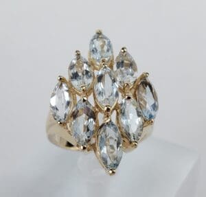 Gold ring with multiple marquise-cut gemstones.