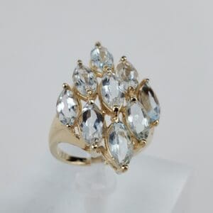 Gold ring with multiple marquise-cut gemstones.