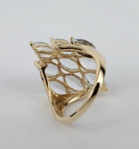 Gold ring with intricate lattice design.
