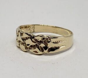 Gold ring with intricate cut-out design.