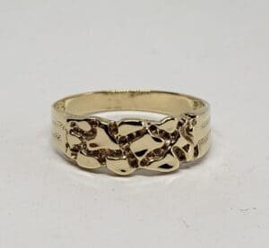 Gold ring with intricate cutout design.