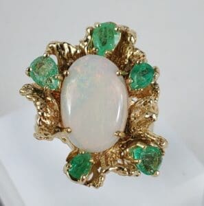 Gold ring with opal and green stones.