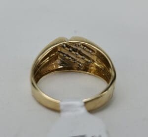 Gold ring with diamond accents inside band.