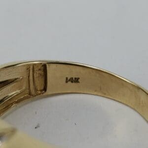 14K gold ring engraving close-up.