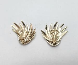 Gold leaf-shaped clip-on earrings displayed.