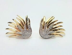 Gold and silver wing-shaped decorative accessories.