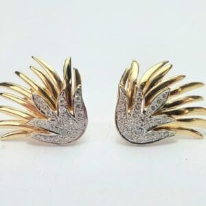 Gold and silver wing-shaped decorative accessories.