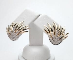 Gold and silver abstract earrings on display.