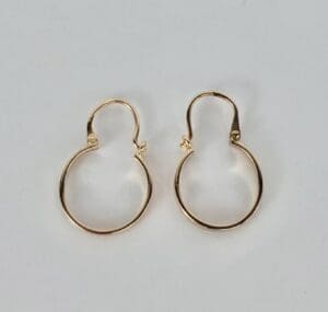 Gold hoop earrings on white background.