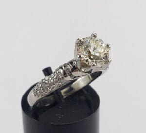 Silver ring with large diamond on display.