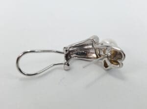 Silver earring with pearl and clasp.