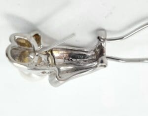 Silver metal rabbit figure with wire frame.