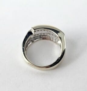 Silver ring with unique design on white.