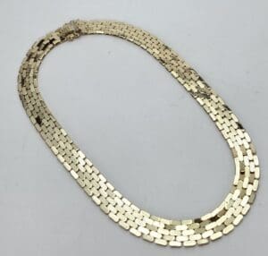 Gold chain necklace on white background.