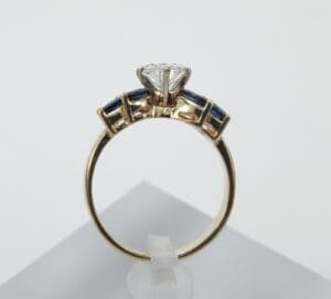 Gold ring with gemstones and diamond setting.