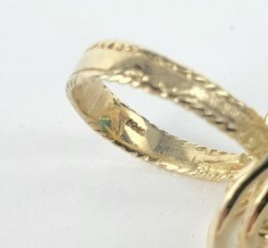 Close-up of intricate gold ring design.