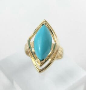 Gold ring with blue stone centerpiece.