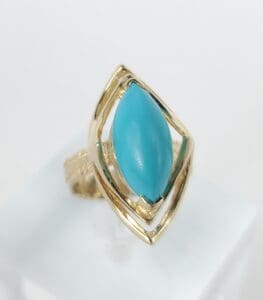 Gold ring with blue marquise stone.