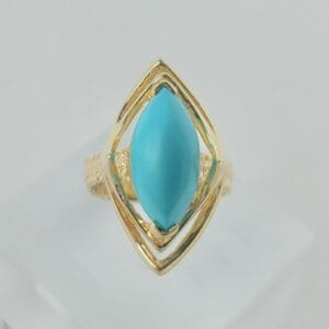 Gold ring with turquoise marquise stone.