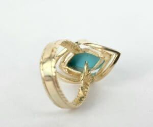Gold ring with blue gemstone design.