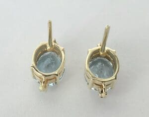 Gold earrings with blue gemstones.